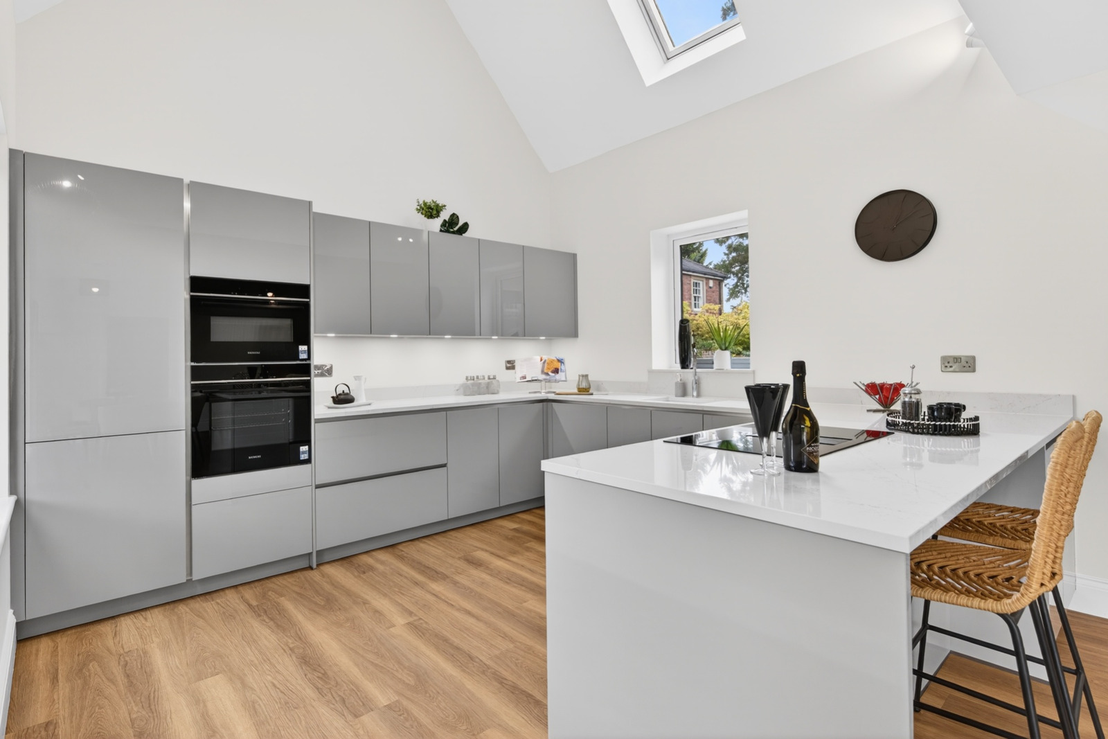 Häcker kitchen with Siemens integrated ovens, Silestone Quartz island and Velux skylight.