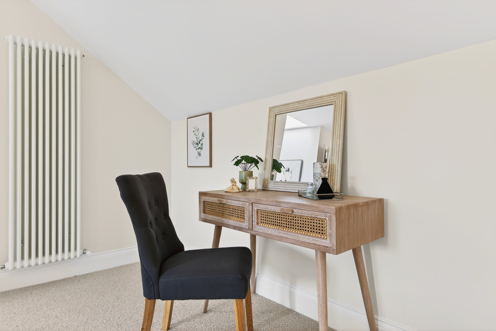 Bedroom dressing area with Kersaint Cobb wool carpet, column radiator and vaulted ceiling.