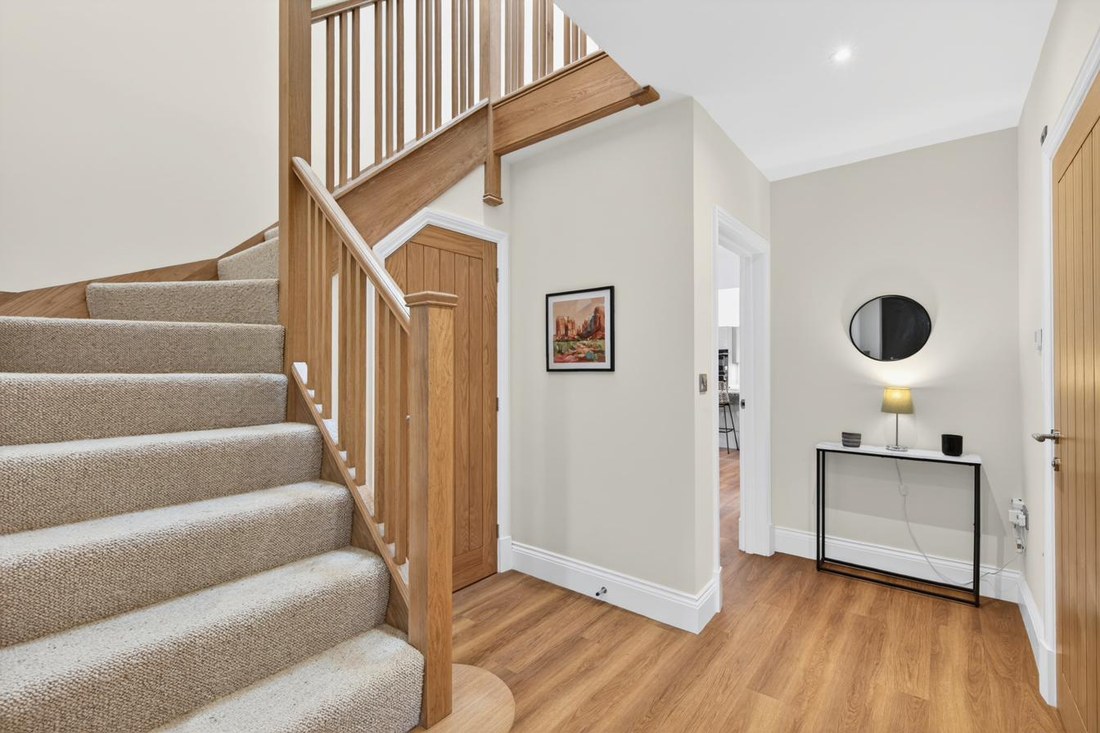 Solid oak staircase and entrance hall with oak internal doors.