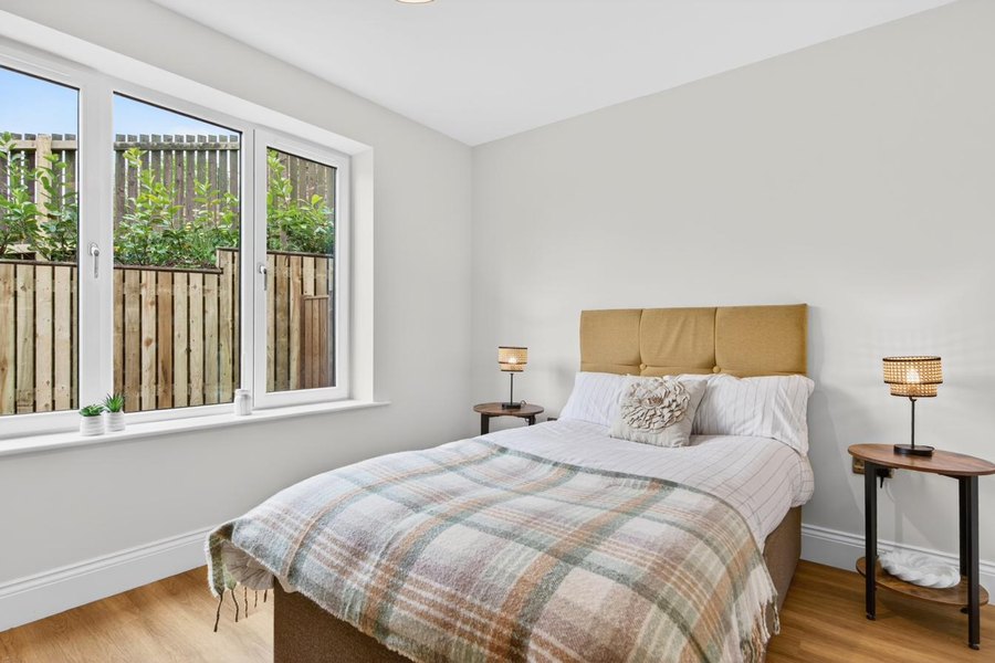 Second bedroom at Orchard Place with vaulted ceiling, Velux rooflight and natural light — Cumbria new-build bungalow.