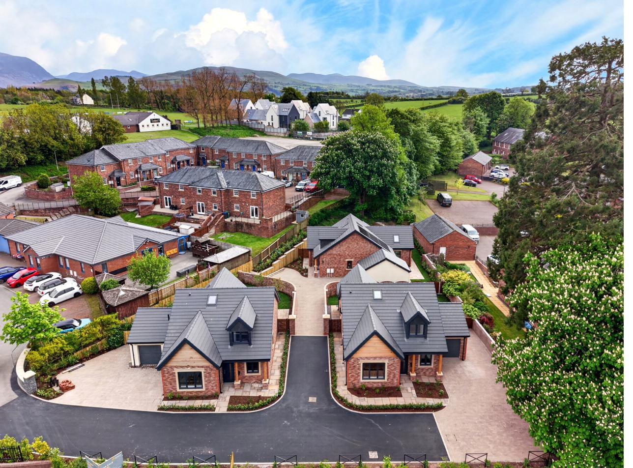 Aerial view of Orchard Place with the Lake District fells in the distance.