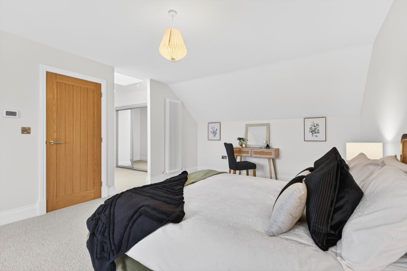 Spacious bedroom with vaulted ceiling, dressing area and en-suite.