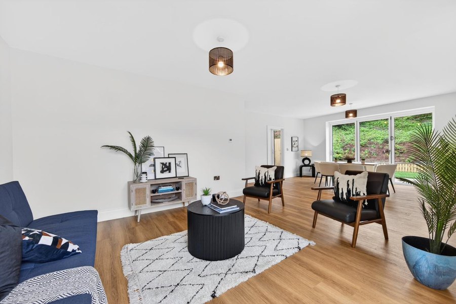Dining area with natural light from bi-fold doors and Velux skylights.