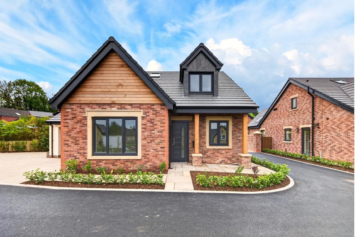 The three dormer bungalows at Orchard Place from the shared driveway.