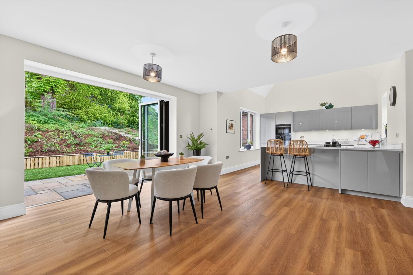 Open-plan kitchen and dining with bi-fold doors to the garden and Amtico flooring.